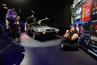 Kamia Evans (right) poses as Christianna Braddix takes her picture after Celebrity Attractions’ 2024-25 Broadway Season Announcement on Wednesday, April 17, 2024, at the Robinson Center in Little Rock. The DeLorean in the background is to promote Back to the Future the Musical, which will run March 11-16, 2025.(Arkansas Democrat-Gazette/Thomas Metthe)